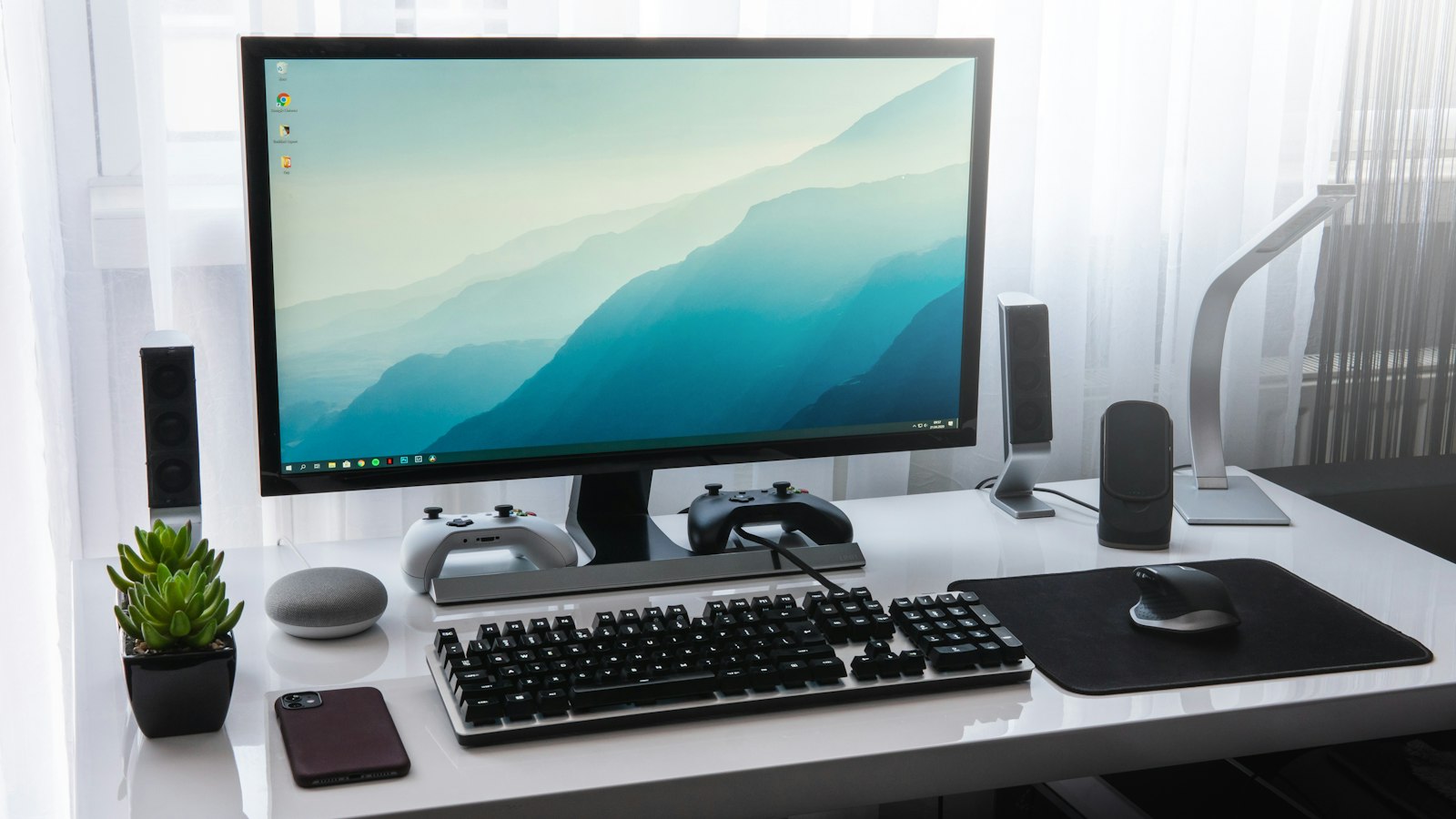 Desktop PC with a wide monitor on a dark desk